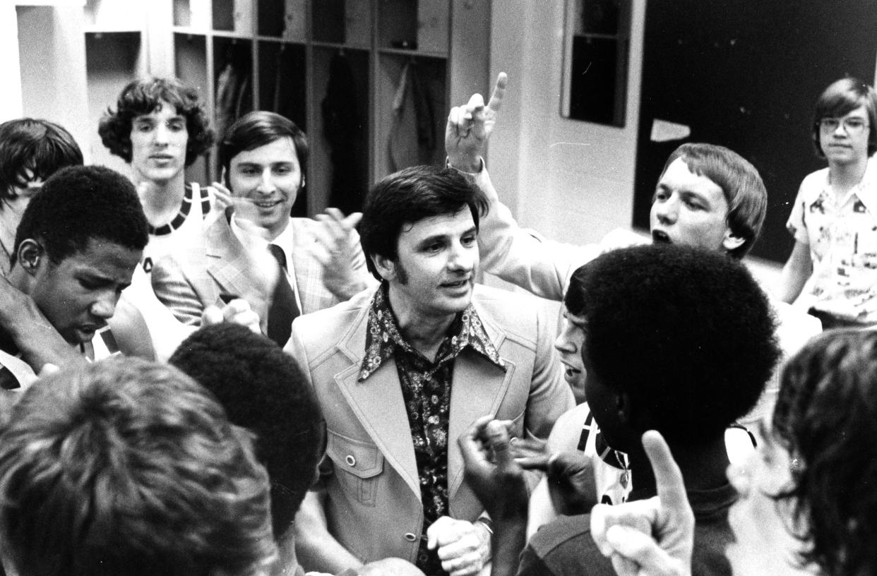 Legendary Barberton High School boys basketball coach Jack Greynolds Sr. surrounded in the locker room in March 1976.