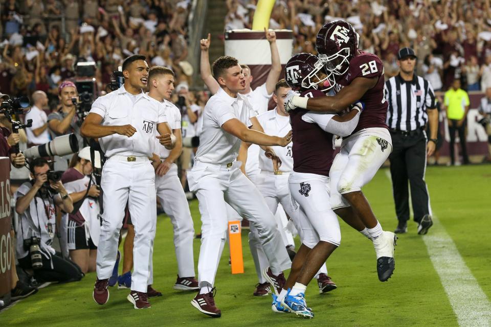 Texas A&M receiver Ainias Smith (0) celebrates his touchdown with Isaiah Spiller (28) in the first quarter against Alabama.