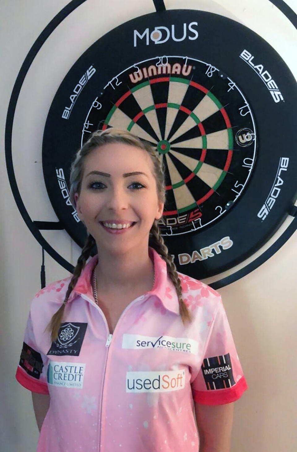 Britain's premier female darts player Fallon Sherrock poses for a photo in Milton Keynes, England, Friday April 24, 2020. Sherrock became the first woman to beat a man at the darts world championship late last year, breaking down barriers in a game that is usually considered to be a man's domain. It proved to be a life-changing experience and although she is now on lockdown because of the coronavirus she will regularly play in future men's events, Sherrock tells The Associated Press Friday April 24, 2020. (Sue Sherrock via AP)