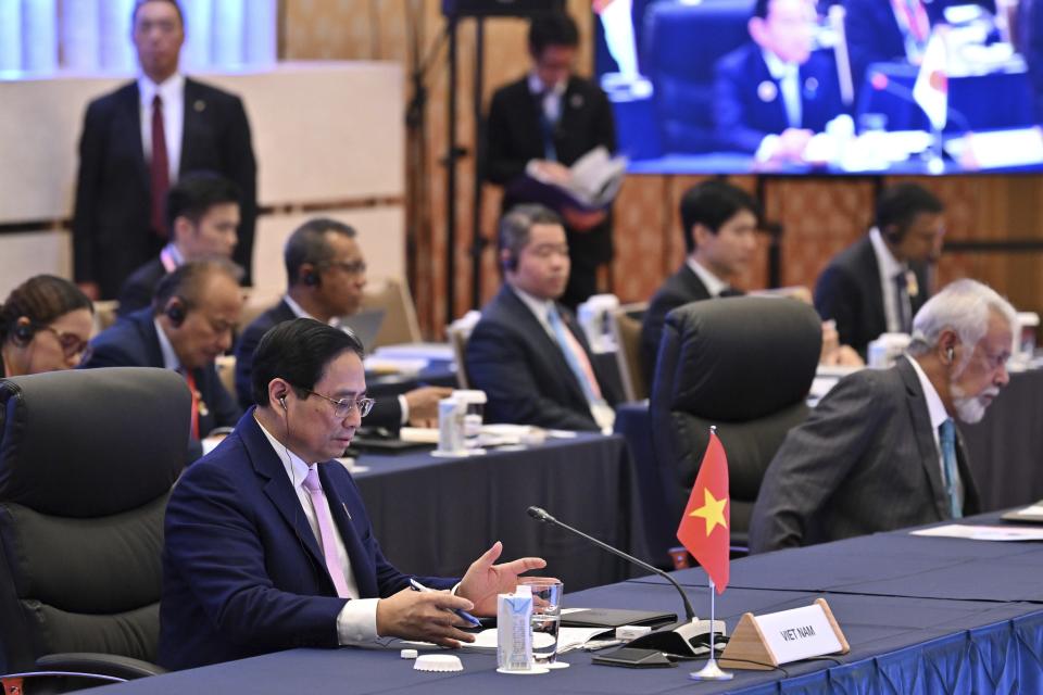 Vietnam's Prime Minister Pham Minh Chinh, left, attends the opening session of the ASEAN-Japan Commemorative Summit Meeting at the Hotel Okura Tokyo in Tokyo Sunday, Dec. 17, 2023. (Kazuhiro Nogi/Pool Photo via AP)