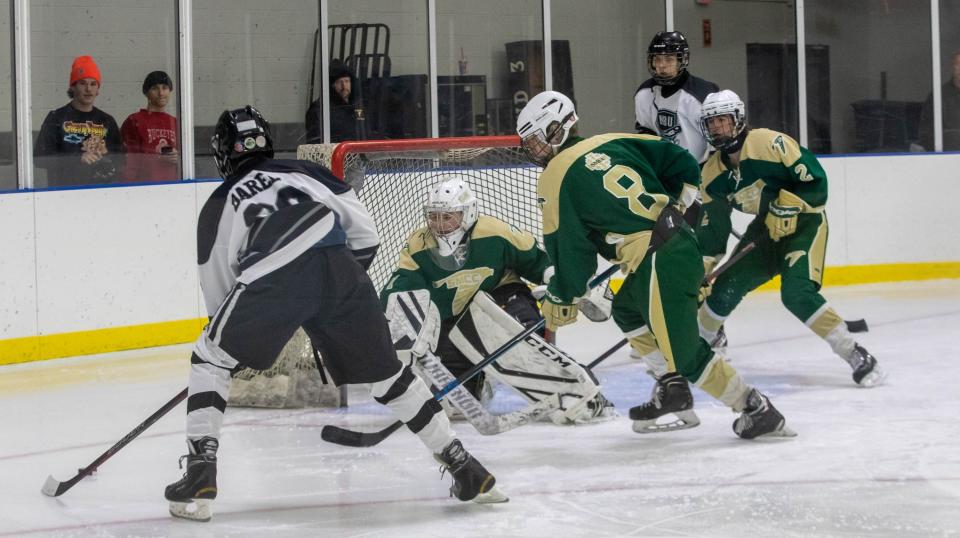 SMCC goalie Peter Provost prepares to stop a shot from Huron United's Jaxon Barela (98) as SMCC teammates Owen McLaughlin (8) and Griffin Worden (2) defend and Huron's Brendan Eskew (22) looks on Tuesday night.