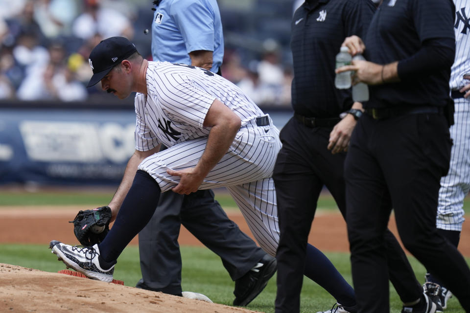 New York Yankees' Carlos Rodon, front left, stretches before being pulled during the third inning of a baseball game against the Houston Astros at Yankee Stadium, Sunday, Aug. 6, 2023, in New York. (AP Photo/Seth Wenig)