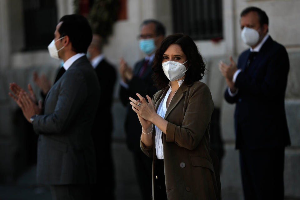 MADRID, SPAIN - MAY 27: President of the Community of Madrid Isabel Diaz Ayuso (C) stands one minute silence at Sol square in Madrid as the government has declared 10 days of official mourning to honor those who lost their lives in the new type of coronavirus (Covid-19) in Spain on May 27, 2020. (Photo by Burak Akbulut/Anadolu Agency via Getty Images)