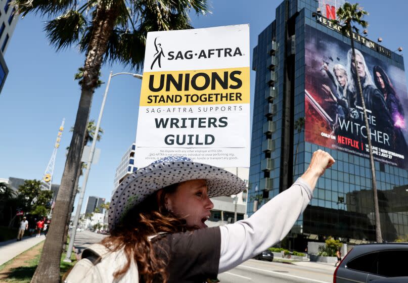 LOS ANGELES, CALIFORNIA - JULY 12: SAG-AFTRA member Christine Robert pickets in solidarity with striking WGA (Writers Guild of America) workers outside Netflix offices on July 12, 2023 in Los Angeles, California. Members of SAG-AFTRA, which represents actors and other media professionals, may go on strike by 11:59 p.m. today which could shut down Hollywood productions completely with the writers in the third month of their strike against Hollywood studios. (Photo by Mario Tama/Getty Images)