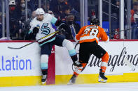 Seattle Kraken's Jordan Eberle, left, and Philadelphia Flyers' Claude Giroux collide during the first period of an NHL hockey game, Monday, Oct. 18, 2021, in Philadelphia. (AP Photo/Matt Slocum)