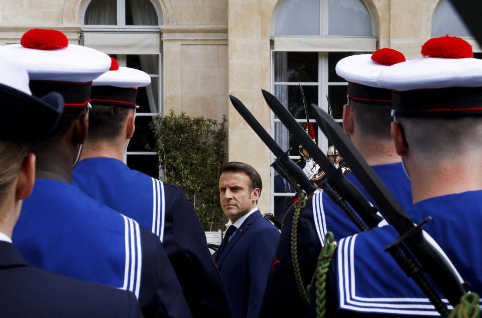 French President Emmanuel Macron reviews military troops during the ceremony of his inauguration for a second term at the Elysee palace, in Paris, France, Saturday, May 7, 2022. Macron was reelected for five years on April 24 in an election runoff that saw him won over far-right rival Marine Le Pen. (Gonzalo Fuentes/Pool via AP)