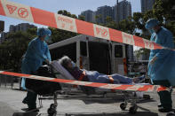 A resident of the nursing home "The Salvation Army Lung Hang Residence for Senior Citizens" is evacuated by medical staff from the Centre for Health Protection, after employees of the nursing home were found to have the coronavirus COVID-19, in Hong Kong, Friday, July 24, 2020. Hong Kong is facing a "critical stage" in its fight against COVID-19, and the government is extending anti-virus measures, Health Secretary Sophia Chan said Wednesday. (AP Photo/Kin Cheung)