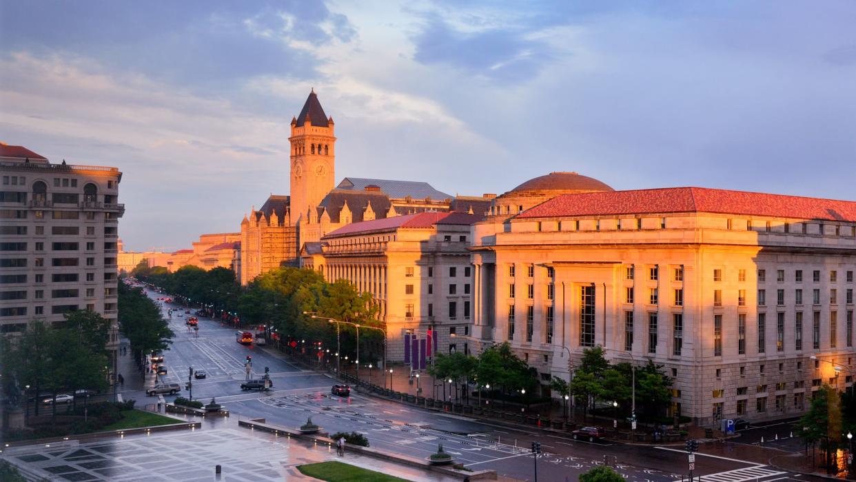 Washington's city street and post office tower at sunrise, Washington, DC, USA.