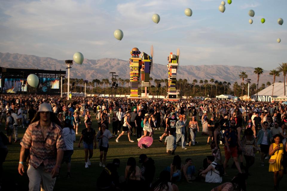 Festivalgoers walk between stages at the Empire Polo Club during the Coachella Valley Music and Arts Festival in Indio, Calif., on Sunday, April 16, 2023. 