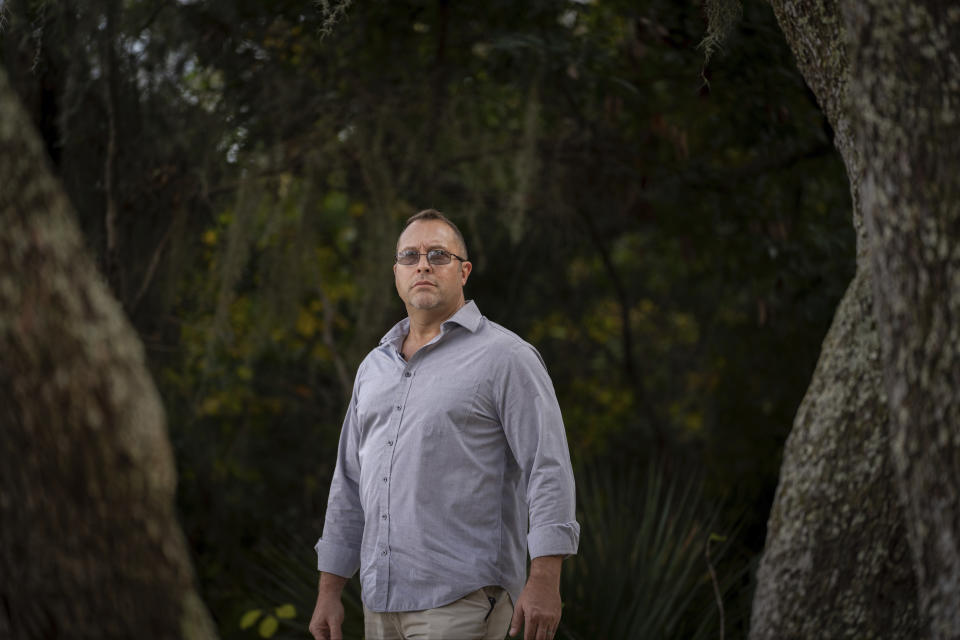 FILE - Joseph Moore stands for a portrait at a park in Jacksonville, Fla., on Wednesday, Dec. 8, 2021. Moore worked for nearly 10 years as an undercover informant for the FBI, infiltrating the Ku Klux Klan in Florida, foiling at least two murder plots, according to investigators, and investigating ties between law enforcement and the white supremacist organization. To keep a lifeline to his true character, Moore says he never used racial slurs while in character - even as his klan brethren tossed them around casually. (AP Photo/Robert Bumsted, File)