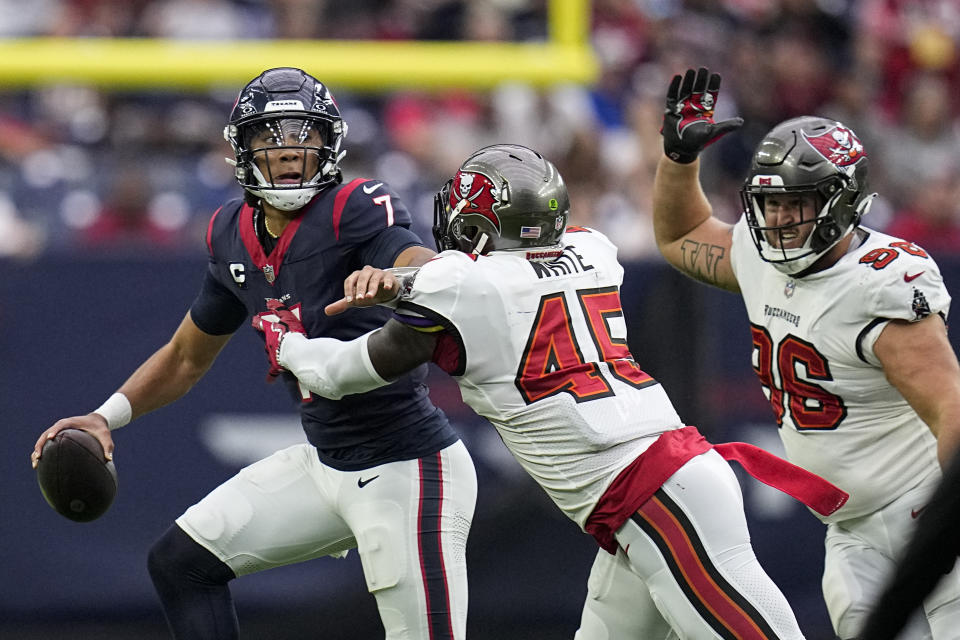 Houston Texans quarterback C.J. Stroud (7) is pressured by Tampa Bay Buccaneers linebacker Devin White (45) and defensive tackle Greg Gaines (96) during the first half of an NFL football game, Sunday, Nov. 5, 2023, in Houston. (AP Photo/Eric Gay)