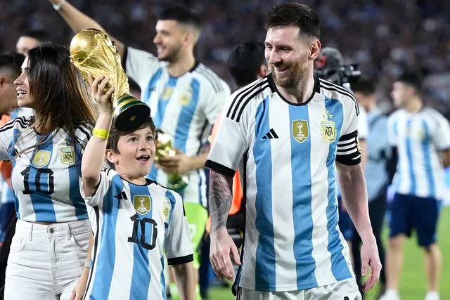 <p>JUAN MABROMATA/AFP via Getty</p> Thiago Messi and father Lionel Messi