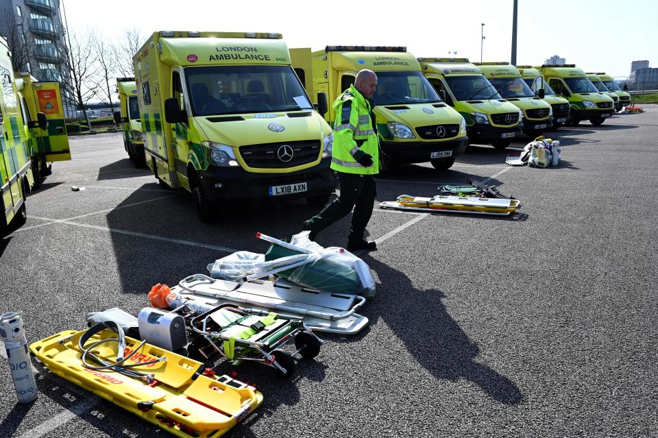 Staff prepare to load equipment into London Ambulance Service vehicles in the east car park at the ExCeL London exhibition centre in London on March 28, 2020, that is being transformed into a field hospital to be known as the NHS Nightingale Hospital to help with the novel coronavirus COVID-19 outbreak. - Britain on March 24 said it will open a 4,000-bed field hospital at a London exhibition centre to treat coronavirus cases in the latest measure to tackle the outbreak after the government ordered a nationwide lockdown. (Photo by Glyn KIRK / AFP) (Photo by GLYN KIRK/AFP via Getty Images)