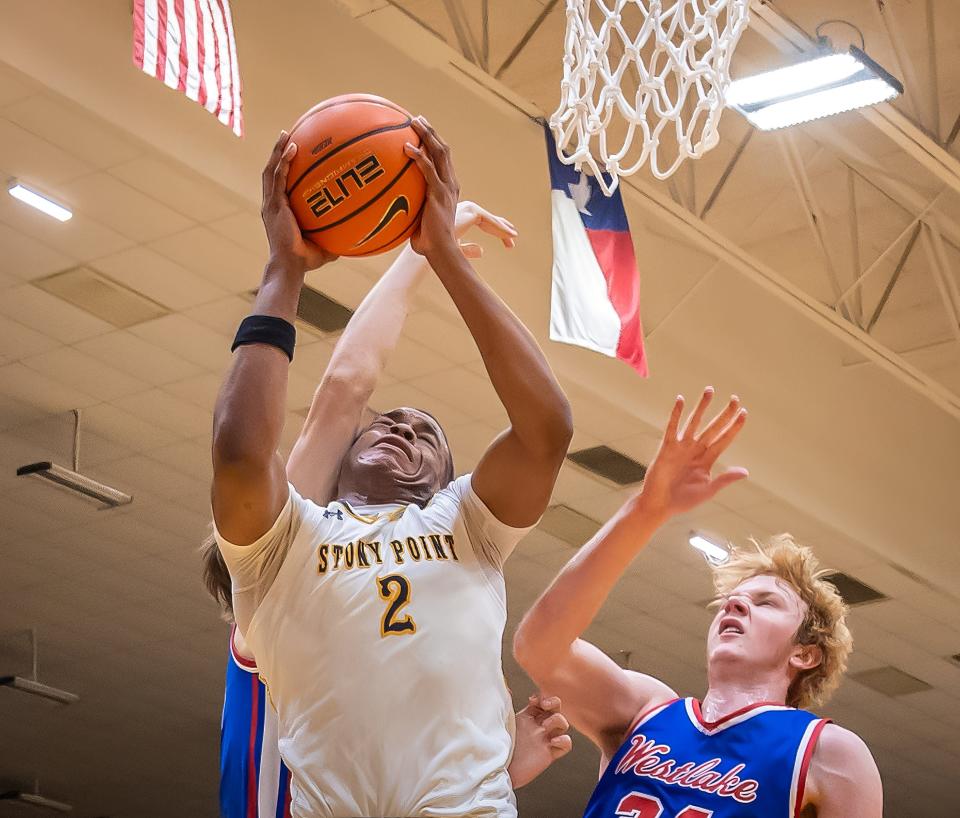 Stoney Point Tigers forward Josiah Moseley (2) shoots to the basket and draws a blocking foul from Westlake Chaparrals during the second period at the Class 6A-IV Regional Quarterfinal boys basketball playoff on Tuesday, Feb 27, 2024, at the Toney Burger Athletic Center - Austin, TX.