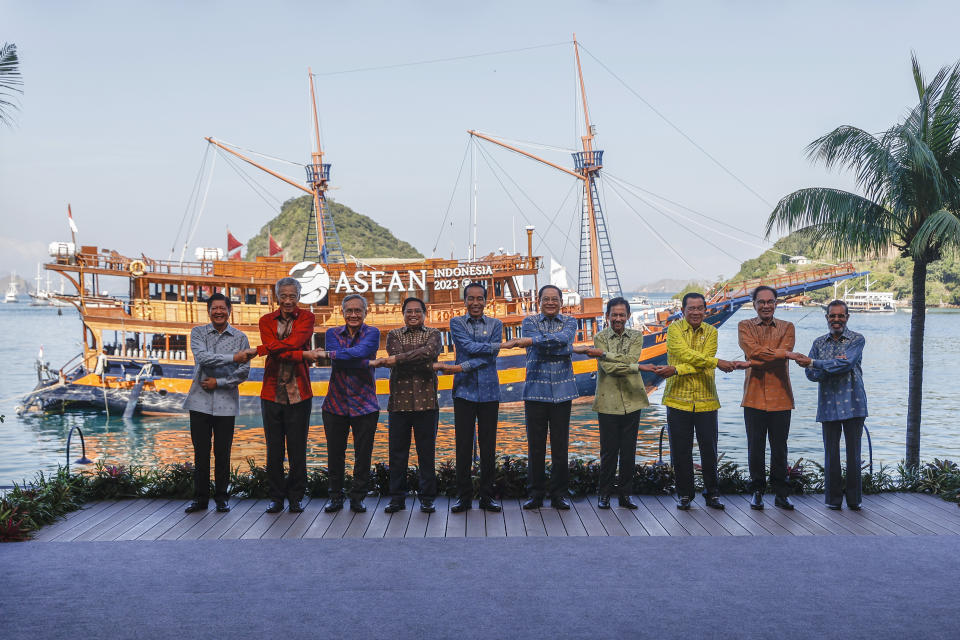 From left to right, Philippines' President Ferdinand Marcos Jr., Singapore's Prime Minister Lee Hsien Loong, Thailand's Deputy Prime Minister and Foreign Minister Don Pramudwinai, Vietnam's Prime Minister Pham Minh Chinh, Indonesia's President Joko Widodo, Laotian Prime Minister Sonexay Siphandone, Brunei's Sultan Hassanal Bolkiah, Cambodia's Prime Minister Hun Sen, Malaysia's Prime Minister Anwar Ibrahim and East Timor's Prime Minister Taur Matan Ruak hold hands for a family photo ahead of the retreat session at the 42nd ASEAN Summit in Labuan Bajo, East Nusa Tenggara province, Indonesia, Thursday, May 11, 2023. (Mast Irham/Pool Photo via AP)