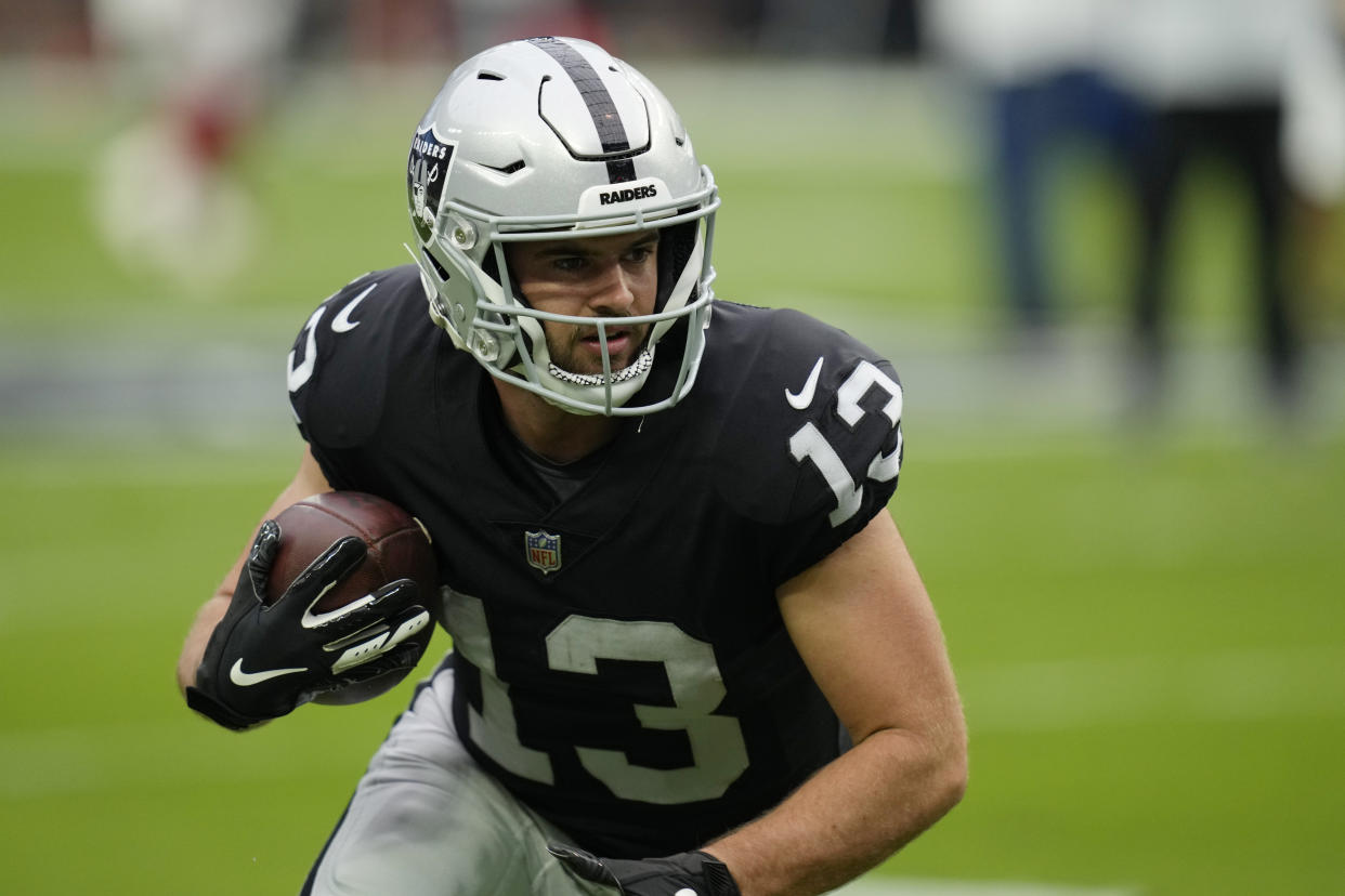 Las Vegas Raiders wide receiver Hunter Renfrow (13) warms up before an NFL football game against the Arizona Cardinals, Sunday, Sept. 18, 2022, in Las Vegas. (AP Photo/John Locher)