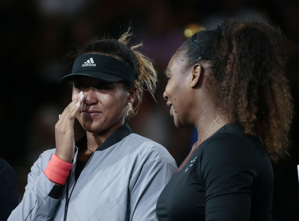 Naomi Osaka, of Japan, wipes a tear as she talks with Serena Williams after Osaka defeated Williams in the women's final of the U.S. Open tennis tournament, Saturday, Sept. 8, 2018, in New York. (AP Photo/Andres Kudacki)