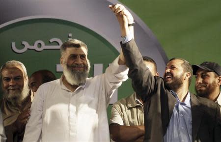 Leading member of the Islamic Jama'a Assem Abdel Maged (L) gestures with other leaders during a protest by Islamists, members of the brotherhood, and supporters of Egyptian President Mohamed Mursi around the Raba El-Adwyia mosque square in the suburb of Nasr City, Cairo, June 28, 2013. REUTERS/Amr Abdallah Dalsh