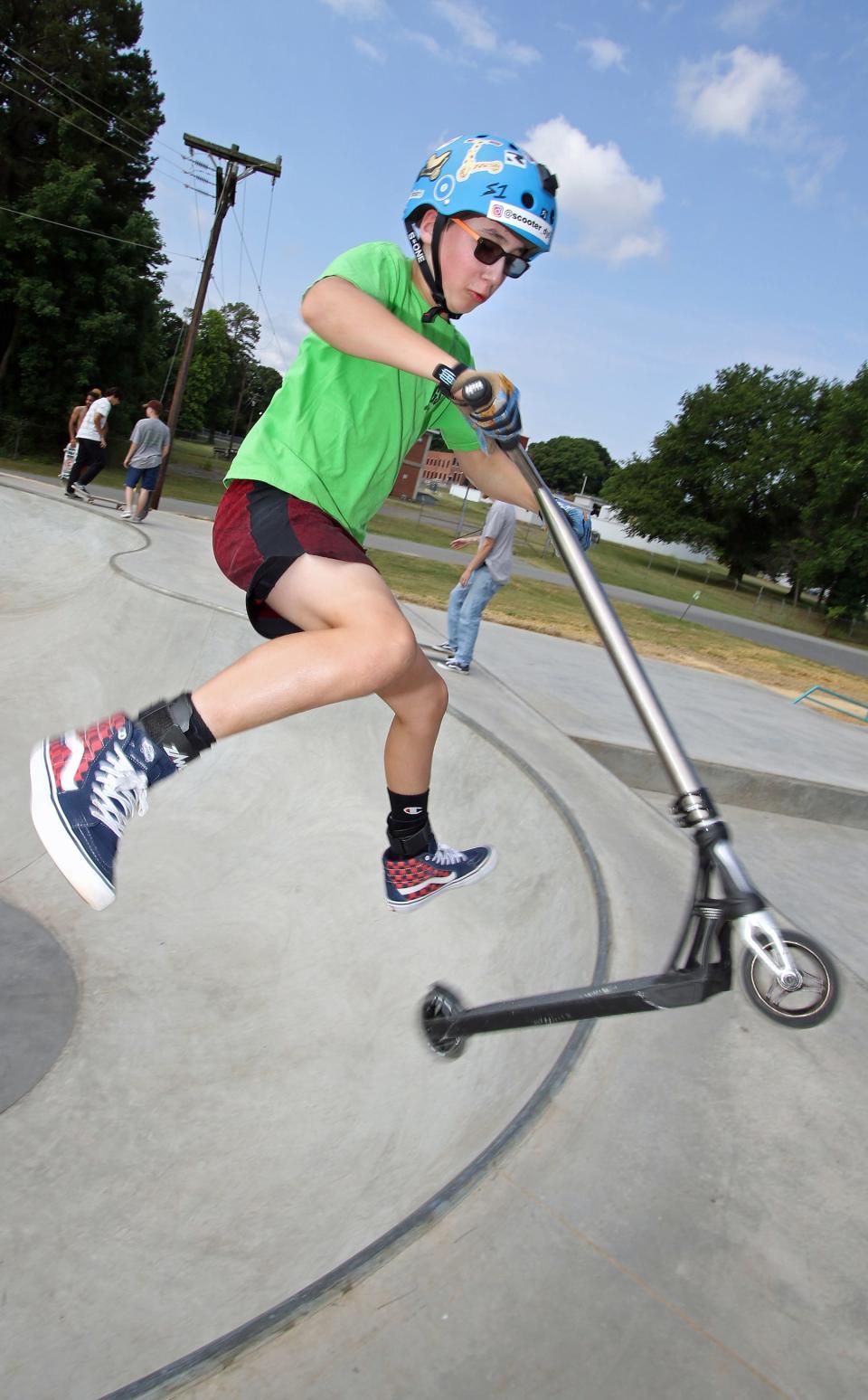 Dylan Messina and his scooter try out the new Belmont Skateboard Park on East Catawba Street during the skate park expo held Saturday, June 25, 2022.
