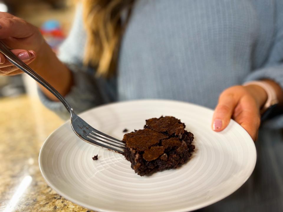 brownie sitting on a plate with a fork