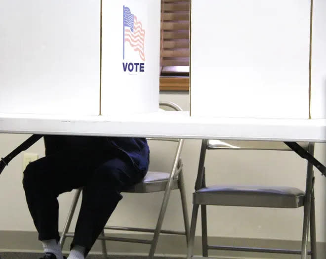 A voter casts their ballot at the Hillsdale Community Library.