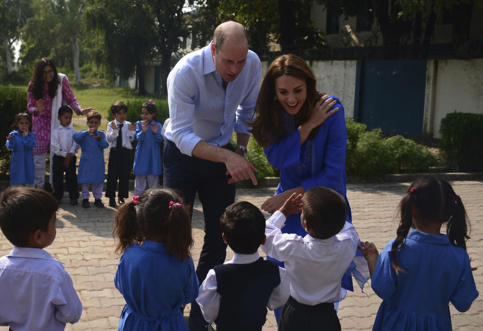 Britain's Prince William and his wife Kate interact with students during their visit to a school outside Islamabad, Pakistan, Tuesday, Oct. 15, 2019. The Duke and Duchess of Cambridge, who are strong advocates of girls' education were greeted by teachers and children. (AP Photo/B.K. Bangash)