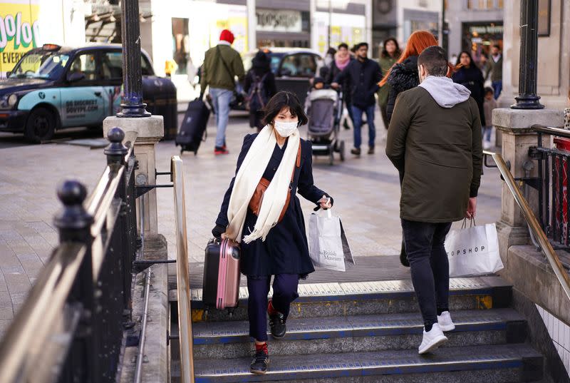 A woman wears a protective face mask in central London