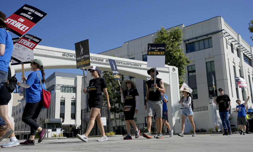 Striking writers and actors take part in a "Bastille Day: Let Them Eat Croissants" rally outside Sony Pictures studio in Culver City, Calif. on Friday, July 14, 2023. This marks the first day actors formally joined the picket lines, more than two months after screenwriters began striking in their bid to get better pay and working conditions. (AP Photo/Mark J. Terrill)