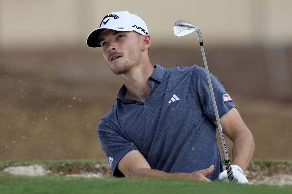 Nicolai Hojgaard of Denmark plays a bunker shot on the third hole during the round three of the DP World Tour Championship golf tournament, in Dubai, United Arab Emirates, Saturday, Nov. 18, 2023. (AP Photo/Kamran Jebreili)