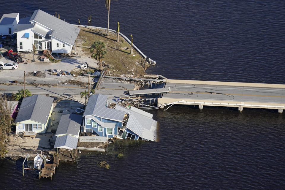 The bridge leading from Fort Myers to Pine Island, Fla., is seen heavily damaged in the aftermath of Hurricane Ian on Pine Island, Fla., Saturday, Oct. 1, 2022. Due to the damage, the island can only be reached by boat or air. (AP Photo/Gerald Herbert)