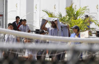 <p>Migrant children walk outside at the Homestead Temporary Shelter for Unaccompanied Children a former Job Corps site that now houses them, on Friday, June 22, 2018, in Homestead, Fla. U.S. officials provided a glimpse into the South Florida facility housing more than 1,000 teen-age migrants, seeking to dispel any suggestions that children are being mistreated. The tour included dorm-style buildings where children sleep up to 12 per room in steel-framed bunk beds, and warehouse-sized, air-conditioned white tents where minors attend classes and watch movies. (Photo: Brynn Anderson/AP) </p>