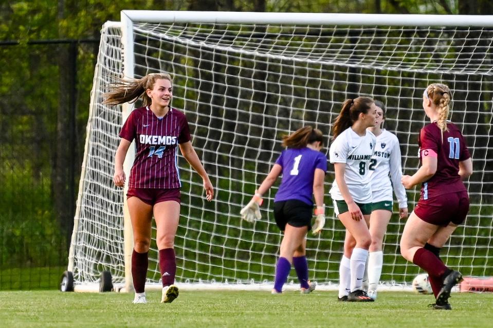 Okemos' Abby Jager, left, celebrates her goal with teammate Kate Farnum, right, during the second half in the game against Williamston on Thursday, May 18, 2023, at Okemos High School.