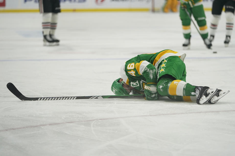 Minnesota Wild defenseman Jared Spurgeon (46) lays on the ground after sustaining an injury during the first period of an NHL hockey game against the Chicago Blackhawks, Sunday, Dec. 3, 2023, in St. Paul, Minn. (AP Photo/Abbie Parr)