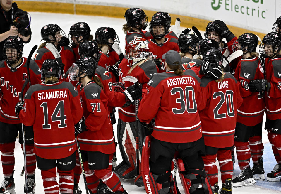 Ottawa players surround goaltender Emerance Maschmeyer (38) after their win against Toronto in a PWHL hockey game in Ottawa, Ontario, Saturday, March 23, 2024. (Justin Tang/The Canadian Press via AP)