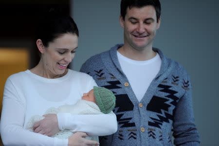 New Zealand Prime Minister Jacinda Ardern carries her newborn baby Neve Te Aroha Ardern Gayford with partner Clarke Gayford as she walks out of the Auckland Hospital in New Zealand, June 24, 2018. REUTERS/Ross Land