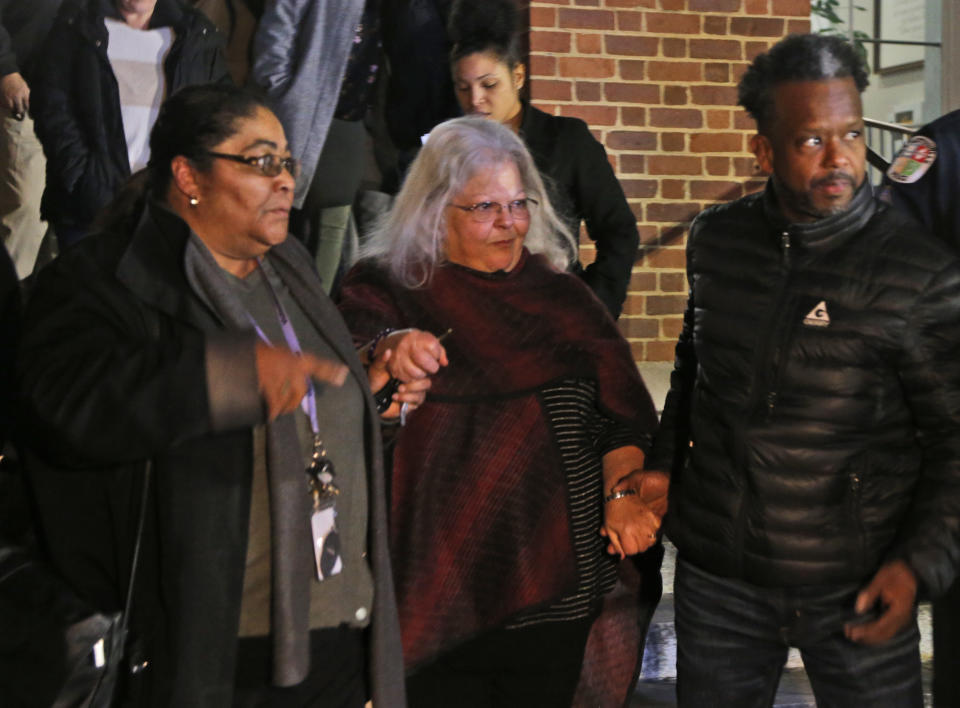 Susan Bro, center, mother of Heather Heyer, is escorted down the steps of the courthouse after a guilty verdict was reached in the trial of James Alex Fields Jr., Friday, Dec. 7, 2018, at Charlottesville General district court in Charlottesville, Va. Fields was convicted of first degree murder in the death of Heather Heyer as well as nine other counts during a "Unite the Right" rally in Charlottesville . (AP Photo/Steve Helber)