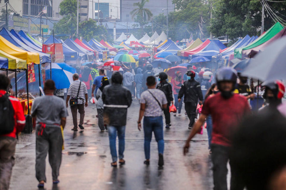 Visitors maintain physical distancing and wear face masks to comply with standard operating procedures (SOP) when visiting the Kampung Baru Ramadan bazaar, April 14, 2021. ― Picture by Hari Anggara