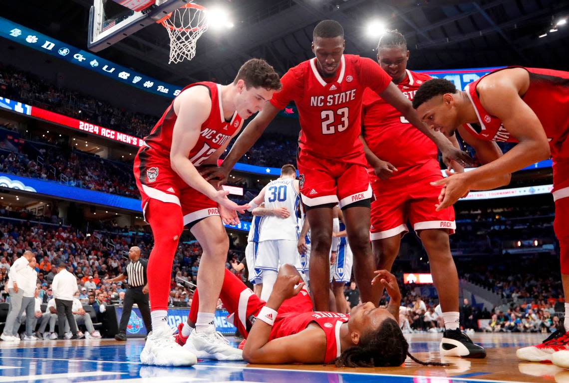 N.C. State’s Michael O’Connell (12), Mohamed Diarra (23), DJ Burns Jr. (30) and Casey Morsell (14) get ready to help up DJ Horne (0) after he was fouled during N.C. State’s 74-69 victory over Duke in the quarterfinal round of the 2024 ACC Men’s Basketball Tournament at Capital One Arena in Washington, D.C., Thursday, March 14, 2024.