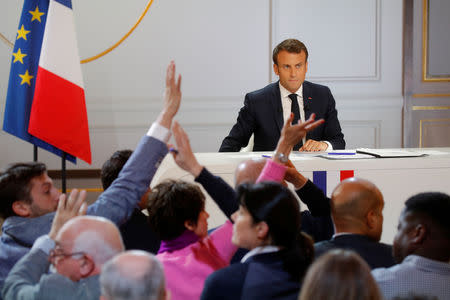 French President Emmanuel Macron reacts as journalists raise their hands to ask questions during a news conference to unveil his policy response to the yellow vests protest, at the Elysee Palace in Paris, France, April 25, 2019. REUTERS/Philippe Wojazer