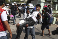 A wounded protester is carried during a protest against the military coup in Mandalay, Myanmar, Sunday, Feb. 28, 2021. Security forces in Myanmar used lethal force as they intensified their efforts to break up protests a month after the military staged a coup. At least four people were reportedly killed on Sunday. (AP Photo)