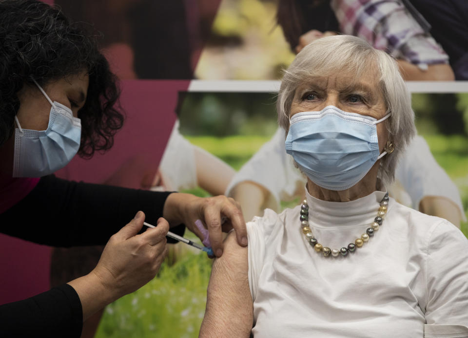 Ans Lock van de Veen, 91, is injected with a COVID-19 vaccine in Apeldoorn, Netherlands, Tuesday, Jan. 26, 2021. Dutch authorities began vaccinating the first of thousands of people aged over 90 years who still live at home. (AP Photo/Peter Dejong)