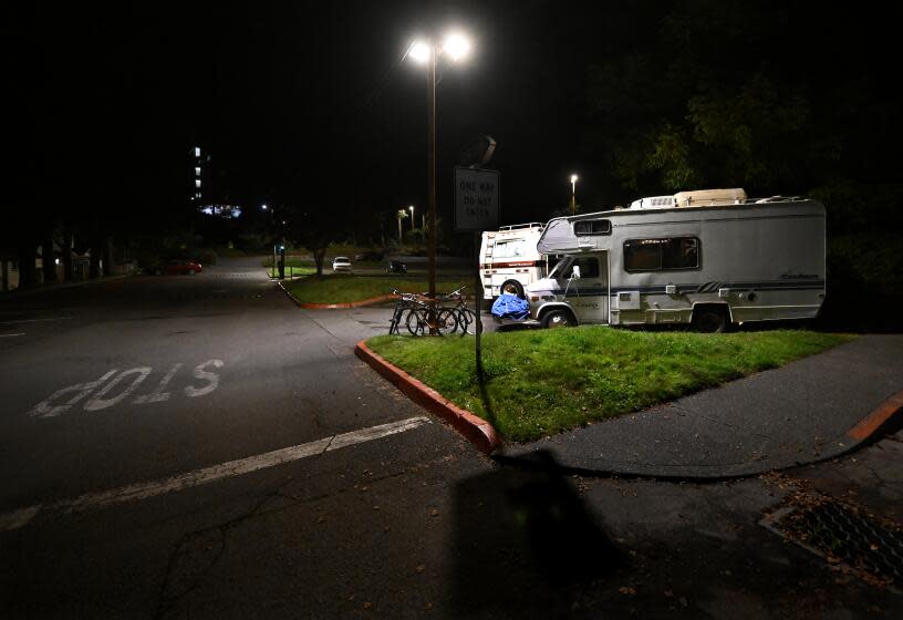 Arcata, California November 17, 2023-Students Brad Butterfield and Maddy Montiel study in their campers on the Cal Poly Humboldt campus. The university recently issued an eviction notice for students who sleep in their vehicles. (Wally Skalij/Los Angeles Times)