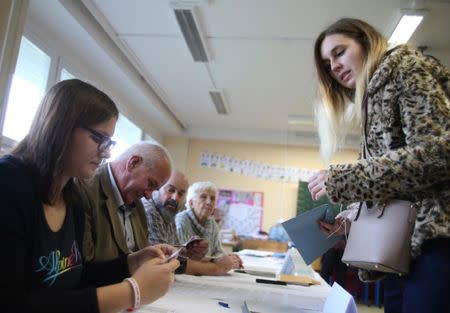 A woman arrives to cast her vote in a parliamentary election at a polliing station in Prague, Czech Republic October 20, 2017. REUTERS/Milan Kammermayer