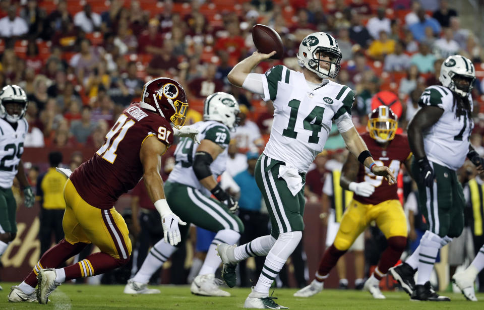 New York Jets quarterback Sam Darnold (14) throws under pressure from Washington Redskins linebacker Ryan Kerrigan, left, during the first half of a preseason NFL football game Thursday, Aug. 16, 2018, in Landover, Md. (AP Photo/Alex Brandon)