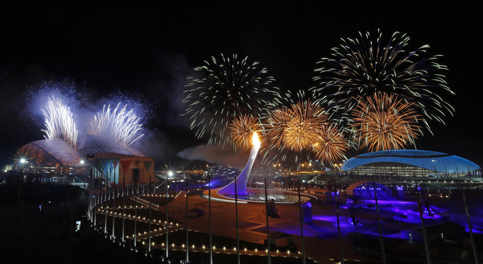 FILE - Fireworks explode over the Olympic Park during the opening of the 2014 Winter Olympics in Sochi, Russia, Friday, Feb. 7, 2014. The Sochi Games were a major project of President Vladimir Putin to enhance the country’s image. (AP Photo/Julio Cortez, File)