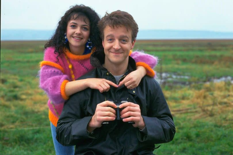 Actors Emma Wray and Paul Bown in character as Brenda Wilson and Malcolm Stoneway in sitcom Watching, circa 1992