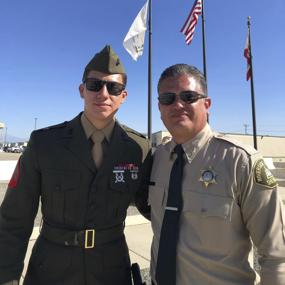 This undated photo released by the Riverside County Sheriff's Department shows U.S. Marine Corps Cpl. Hunter Lopez, 22, left, with his father Capt. Herman Lopez in Riverside, Calif. U.S. Marine Corps Cpl. Hunter Lopez, of Indio, Calif., was killed on Aug. 26, in the bomb attacks in Kabul, Afghanistan. Cpl. Lopez, whose parents work at the Riverside County Sheriff's Department in Southern California, was a sheriff's Explorer for three years before joining the Marine Corps in September 2017, Sheriff Chad Bianco said. Bianco said Lopez planned to follow in his parents' footsteps and become a Riverside County Sheriff's Deputy after his deployment. (Riverside County Sheriff's Department via AP)