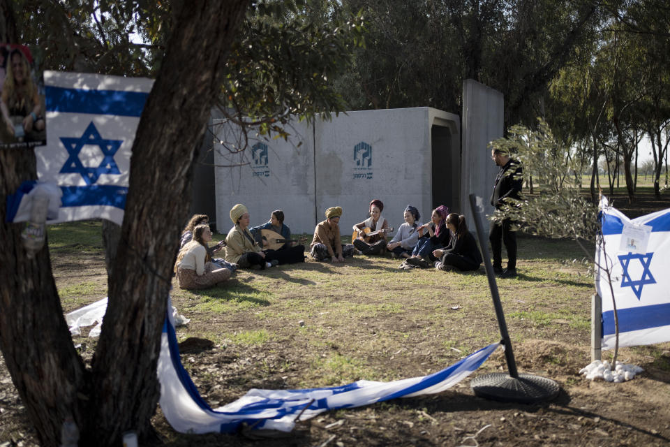 Jewish women sing together as they visit the site where hundreds of revelers were killed or captured by Hamas on Oct. 7, 2023 at the Nova music festival in Re'im, southern Israel, near the Israel-Gaza border, Friday, Jan. 19, 2024. (AP Photo/Maya Alleruzzo)