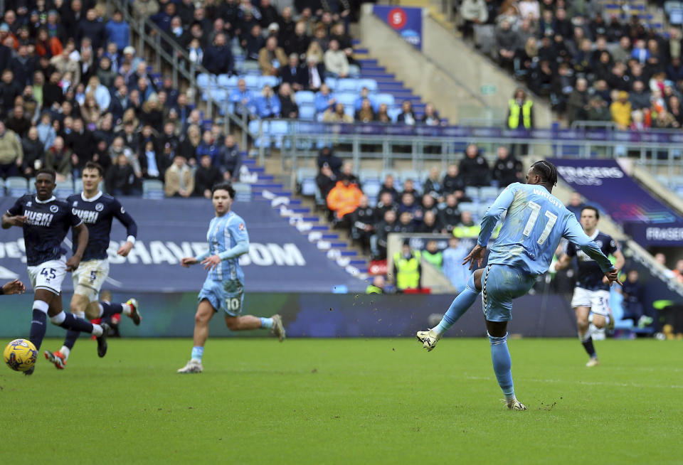 Coventry City's Haji Wright scores their side's second goal of the game during the English League Championship match at the Coventry Building Society Arena, in Coventry, England, Sunday Feb. 11, 2024. Wright, who plays for Coventry City in England’s second-tier Championship, took part in an impromptu on-field game of rock, paper, scissors with teammate Callum O’Hare to determine who took a penalty in the team’s match against Millwall. Wright won it and converted the spot kick by sending the goalkeeper the wrong way, setting Coventry on course for a 2-1 victory on Sunday. (Nigel French/PA via AP)