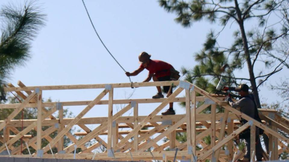 Workers attach roof trusses to a home under construction at Lakewood Ranch on Dec. 5, 2022. Lakewood Ranch remained one of Manatee County’s hottest building areas in 2023.